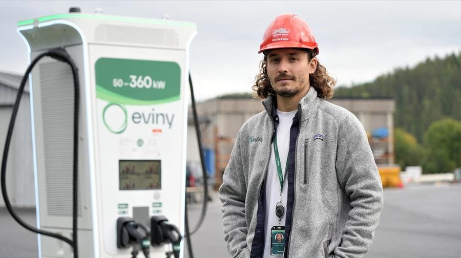 Bilde av Lars Christian Danby Engø, prosjektleder i Eviny Elektrifisering ved siden av en hurtiglader.